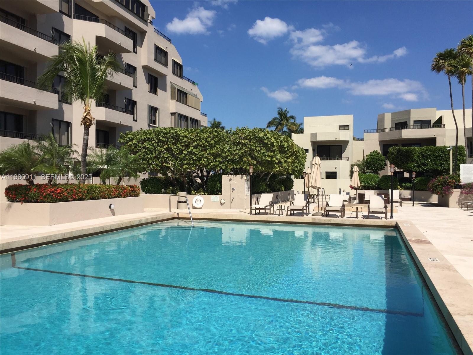 201 Crandon Boulevard, Unit 341 Key Biscayne, FL 33149 - Photo 20 of 25 a view of a swimming pool with outdoor seating