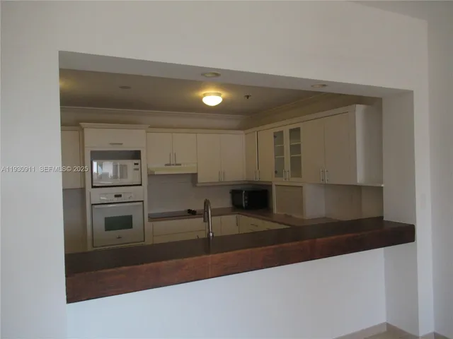 a view of a refrigerator in a kitchen