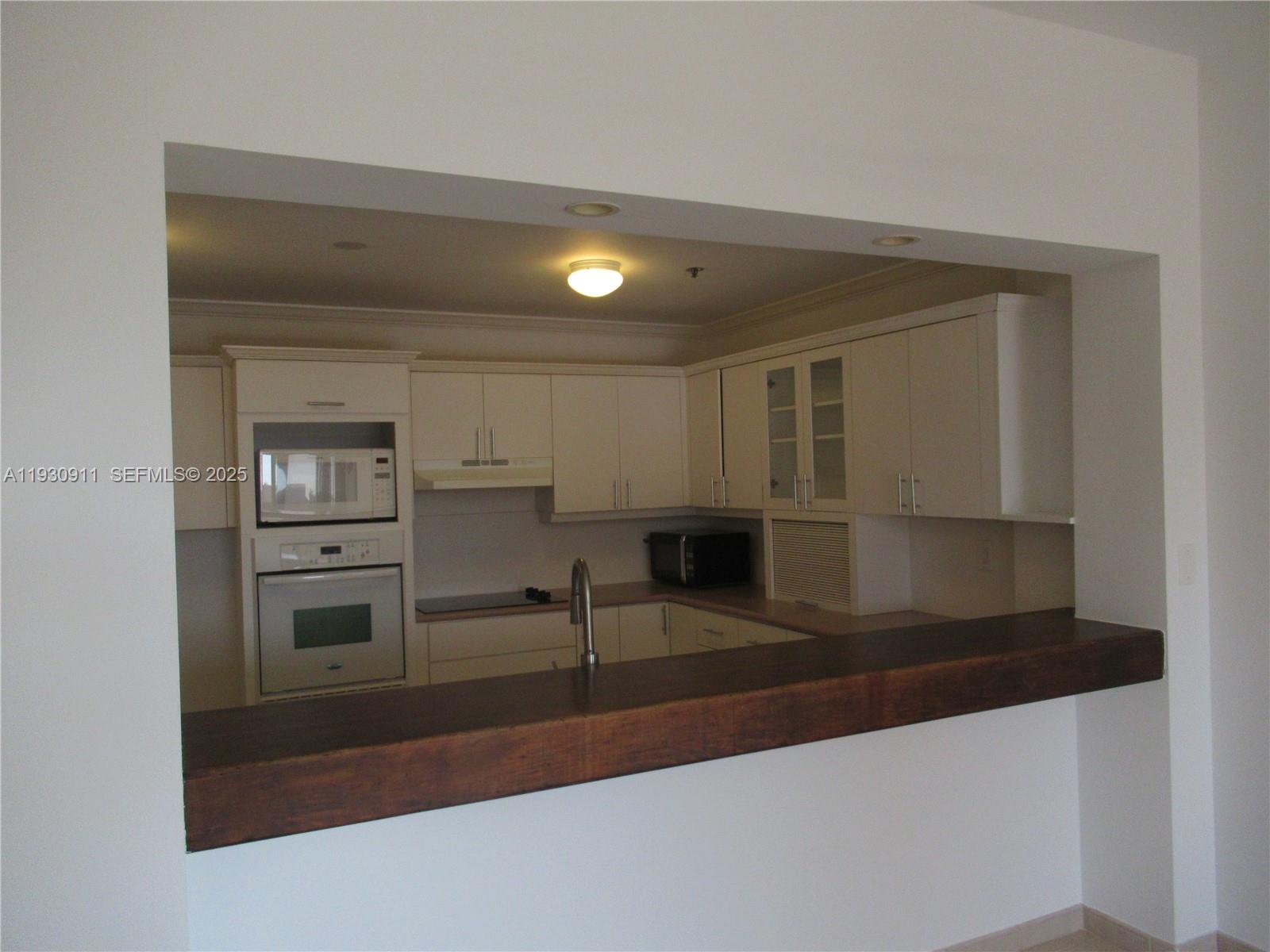 201 Crandon Boulevard, Unit 341 Key Biscayne, FL 33149 - Photo 5 of 25 a view of a refrigerator in a kitchen