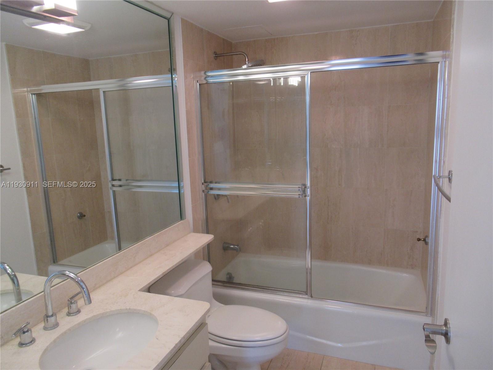 201 Crandon Boulevard, Unit 341 Key Biscayne, FL 33149 - Photo 9 of 25 a bathroom with a shower a toilet and sink