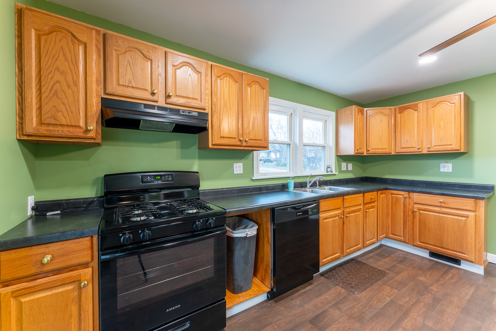 107 Seminary Street Creal Springs, IL 62922 - Photo 29 of 43 a kitchen with granite countertop wooden cabinets and a stove top oven