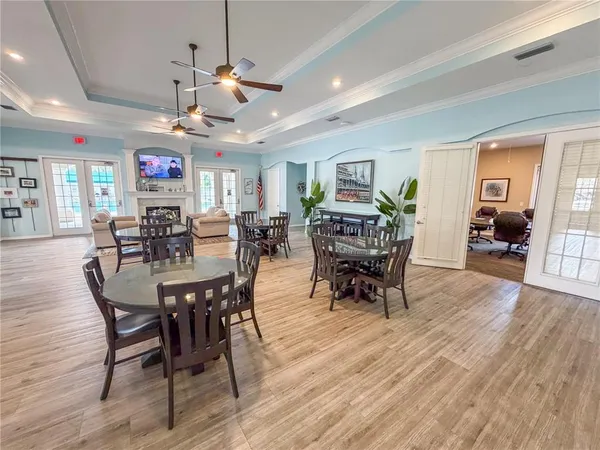 a view of a dining room with furniture wooden floor and chandelier