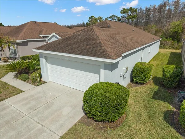 a aerial view of a house next to a yard