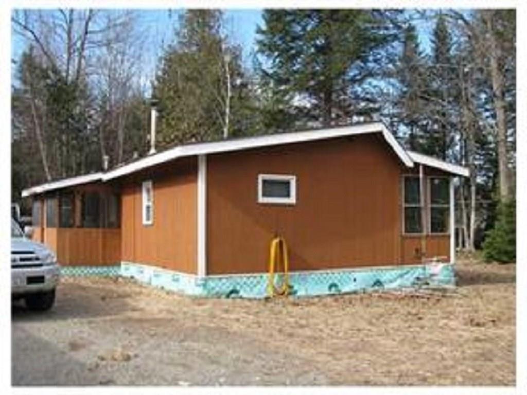 222 Mattamiscontis Road Howland, ME 04448 - Photo 2 of 15 Side view of the cabin, a screened...