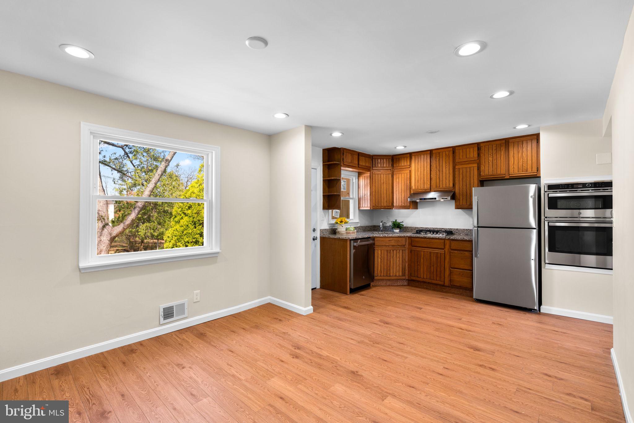 7134 Bexhill Road Windsor Mill, MD 21244 - Photo 15 of 34 a kitchen with stainless steel appliances a refrigerator and a stove top oven