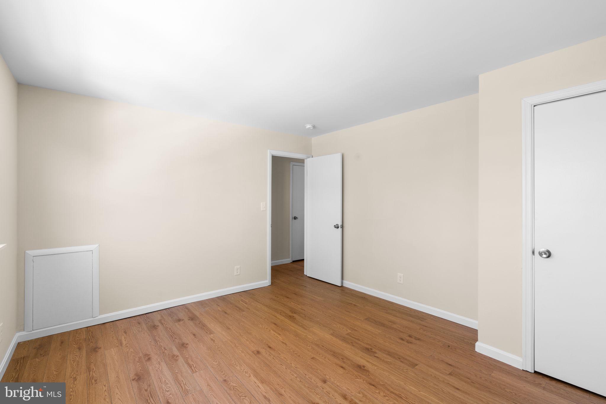 7134 Bexhill Road Windsor Mill, MD 21244 - Photo 18 of 34 a view of an empty room with wooden floor