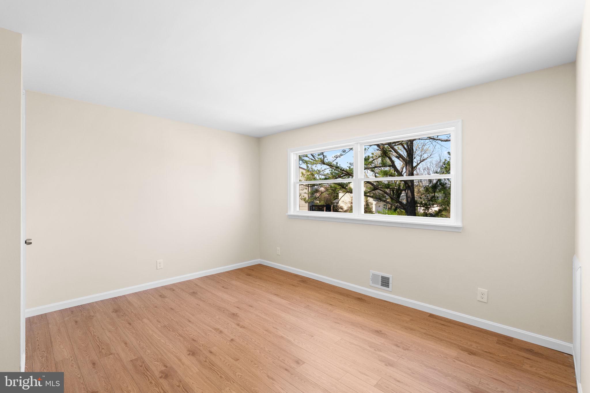 7134 Bexhill Road Windsor Mill, MD 21244 - Photo 19 of 34 an empty room with wooden floor and window