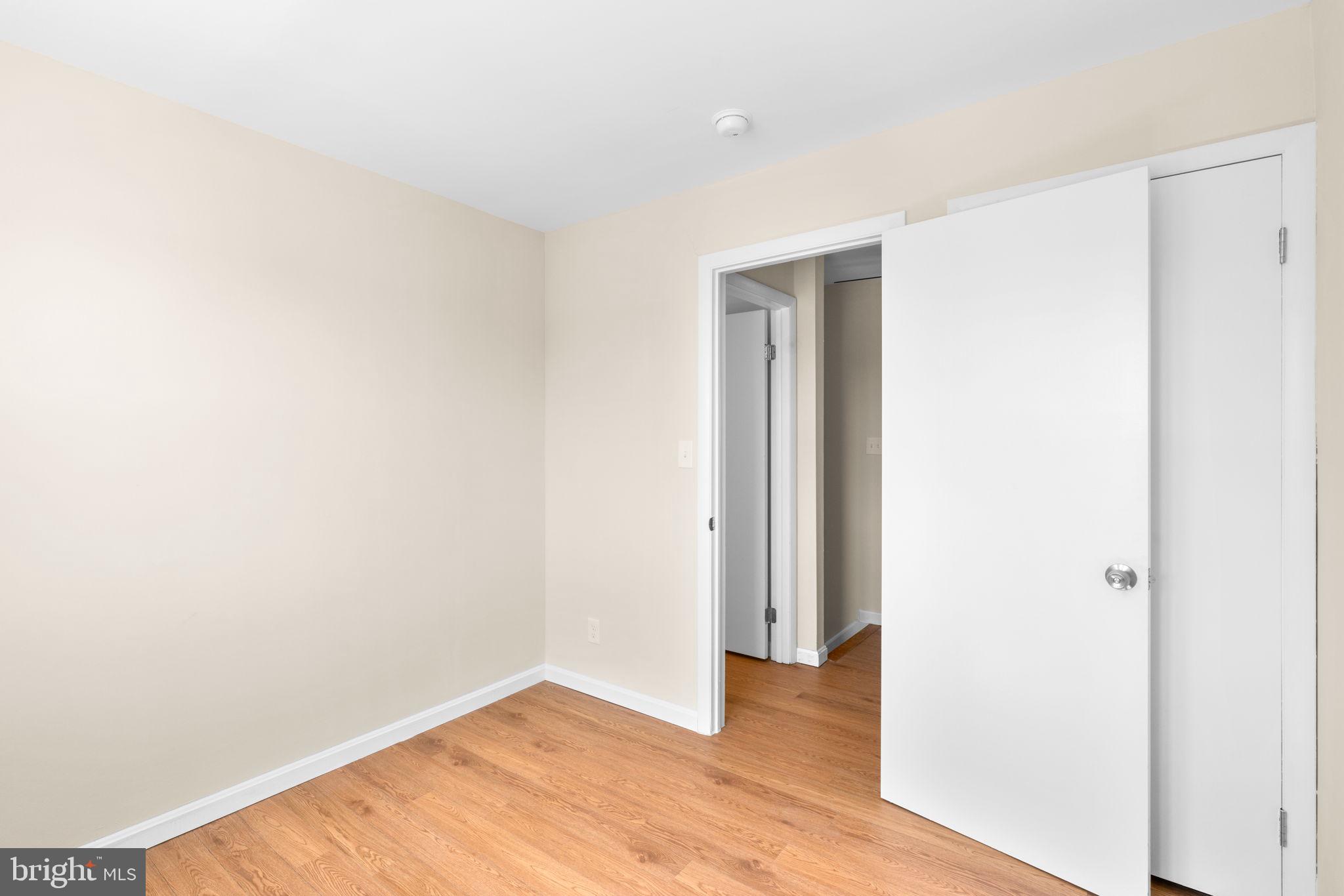 7134 Bexhill Road Windsor Mill, MD 21244 - Photo 21 of 34 a view of an empty room with wooden floor