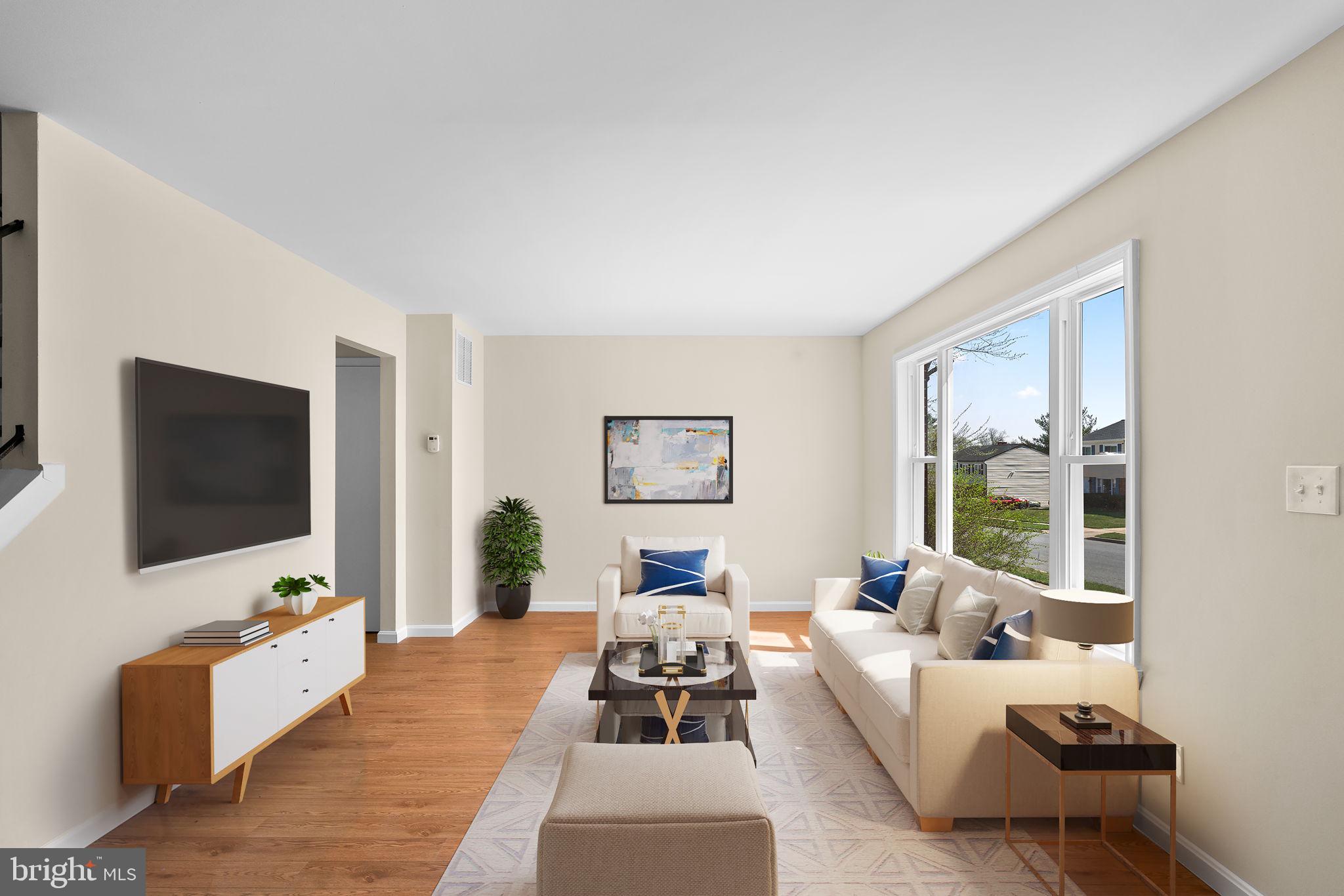 7134 Bexhill Road Windsor Mill, MD 21244 - Photo 3 of 34 a bedroom with furniture and a flat screen tv