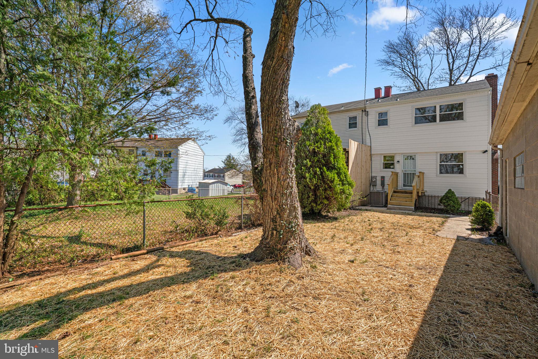 7134 Bexhill Road Windsor Mill, MD 21244 - Photo 32 of 34 a view of a house with a tree in the background