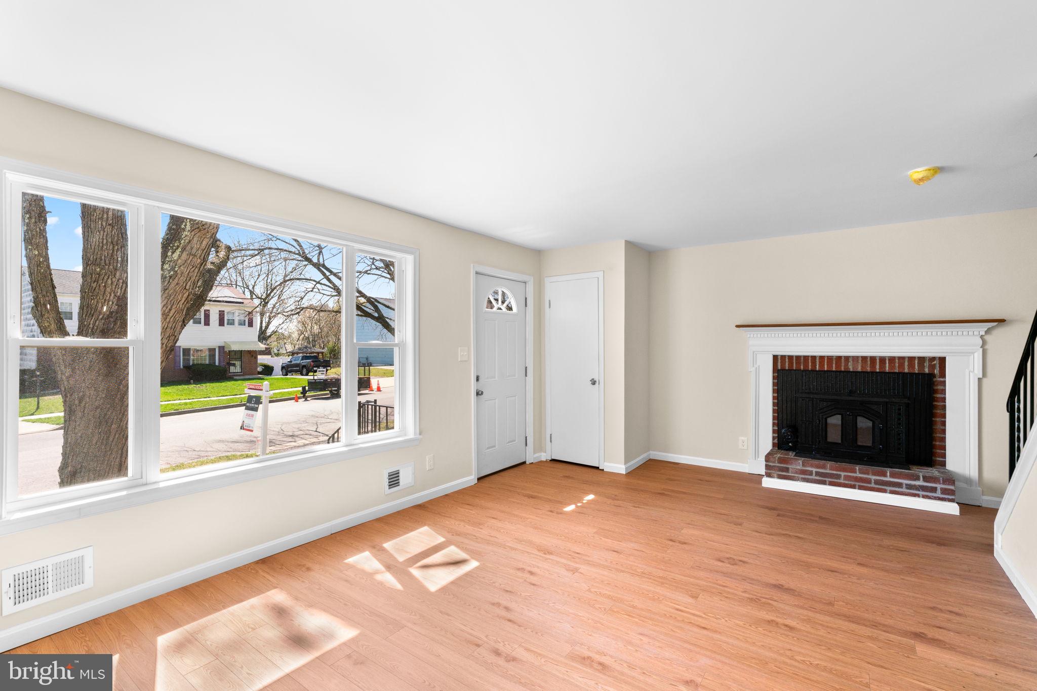 7134 Bexhill Road Windsor Mill, MD 21244 - Photo 5 of 34 a view of an empty room with a fireplace and a window