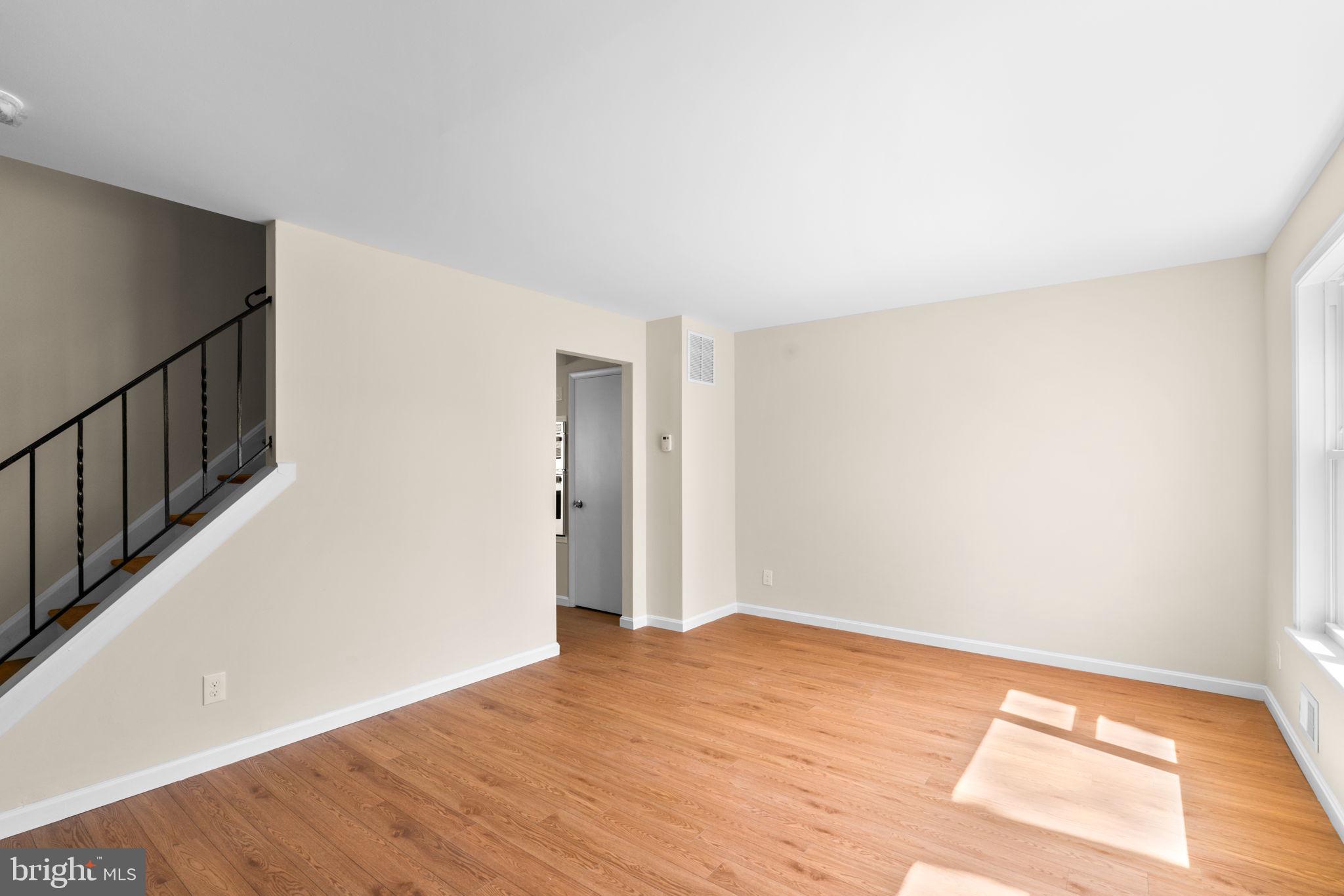 7134 Bexhill Road Windsor Mill, MD 21244 - Photo 7 of 34 a view of an empty room with wooden floor