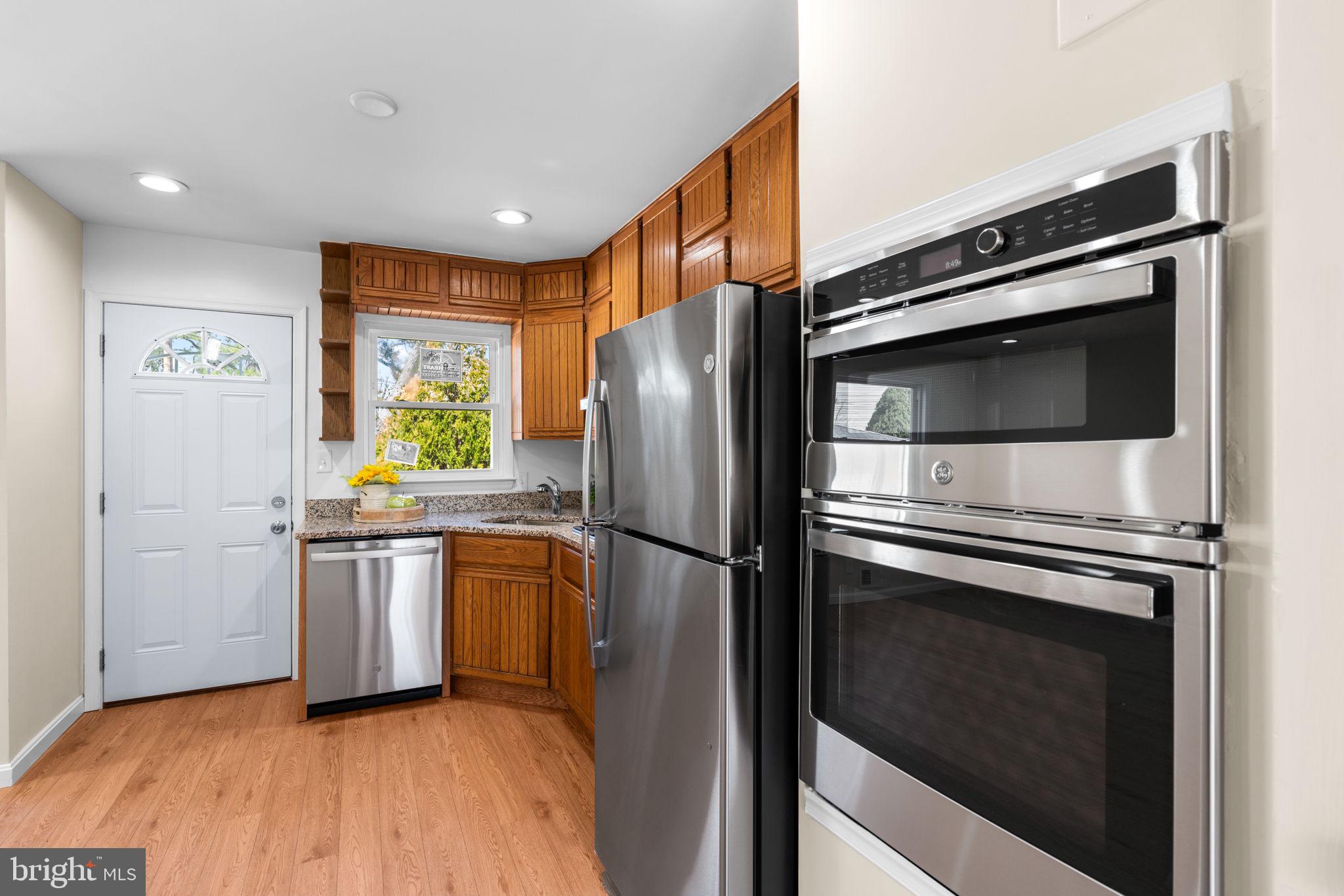 7134 Bexhill Road Windsor Mill, MD 21244 - Photo 9 of 34 a kitchen with a refrigerator stove and microwave