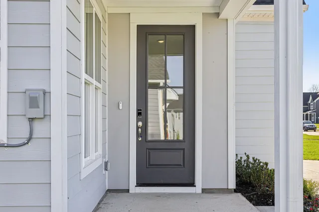 an empty room with windows and fireplace