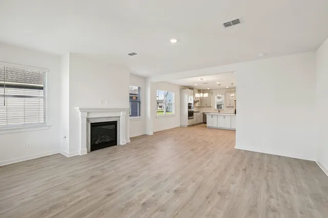 a view of a room with wooden floor and a fireplace