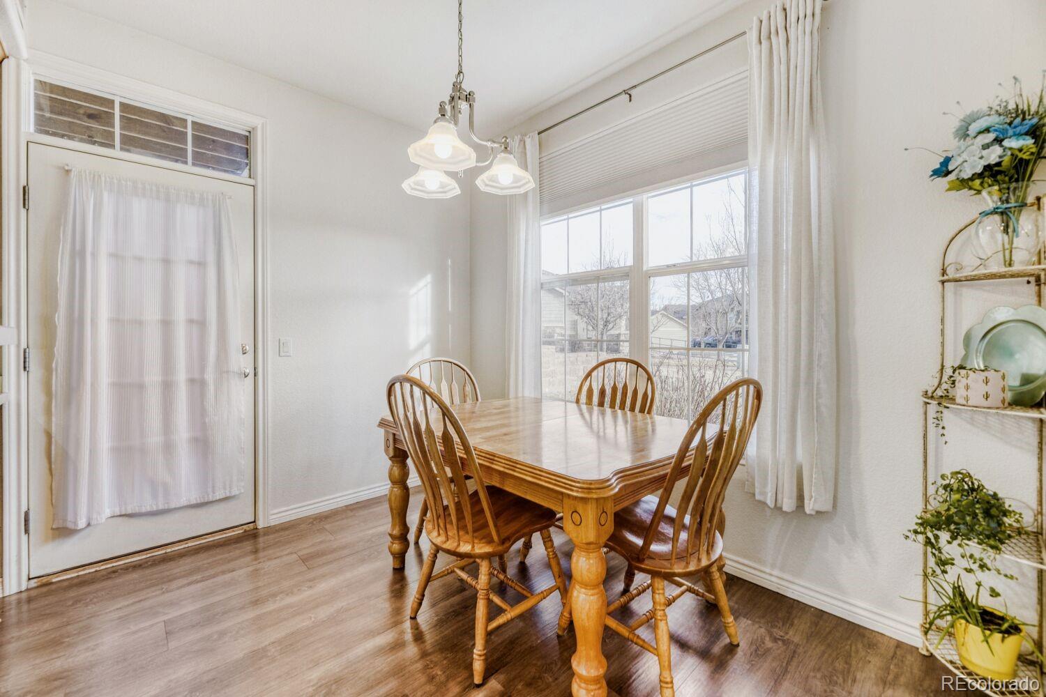 18611 Stroh Road, Unit 5108 Parker, CO 80134 - Photo 9 of 24 a view of a dining room with furniture window and wooden floor