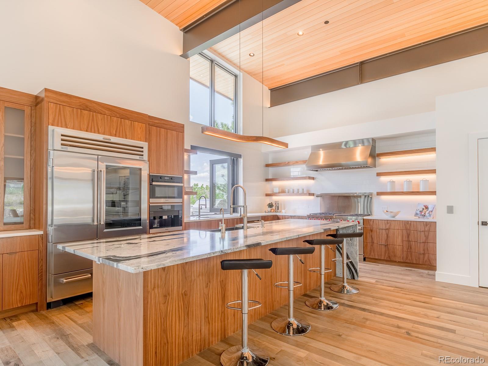 7526 Spring Drive Boulder, CO 80303 - Photo 12 of 40 a kitchen with stainless steel appliances granite countertop a stove and cabinets