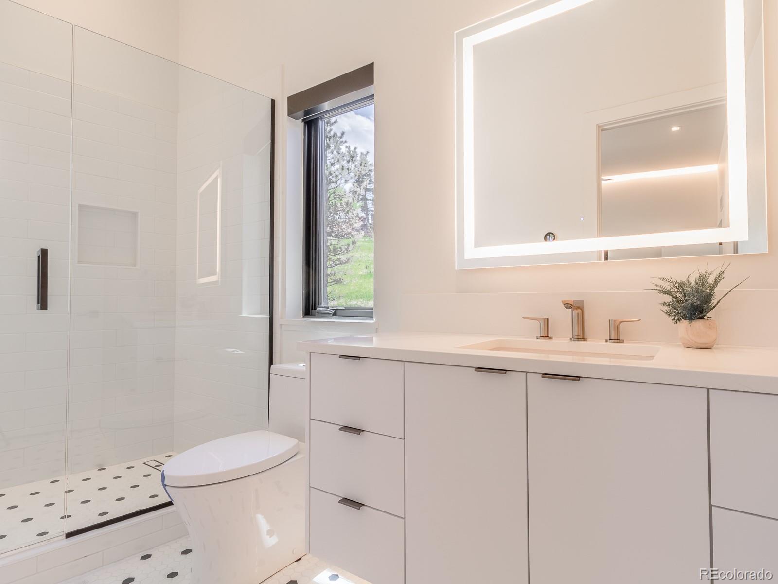 7526 Spring Drive Boulder, CO 80303 - Photo 34 of 40 a bathroom with a sink a toilet and shower
