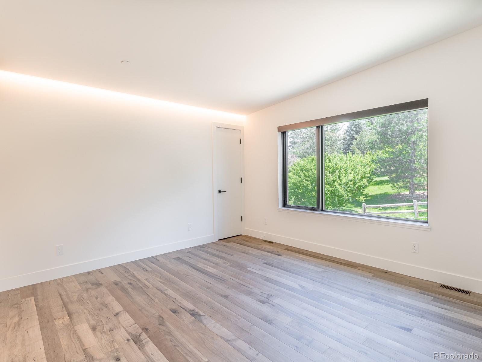 7526 Spring Drive Boulder, CO 80303 - Photo 35 of 40 an empty room with wooden floor and windows