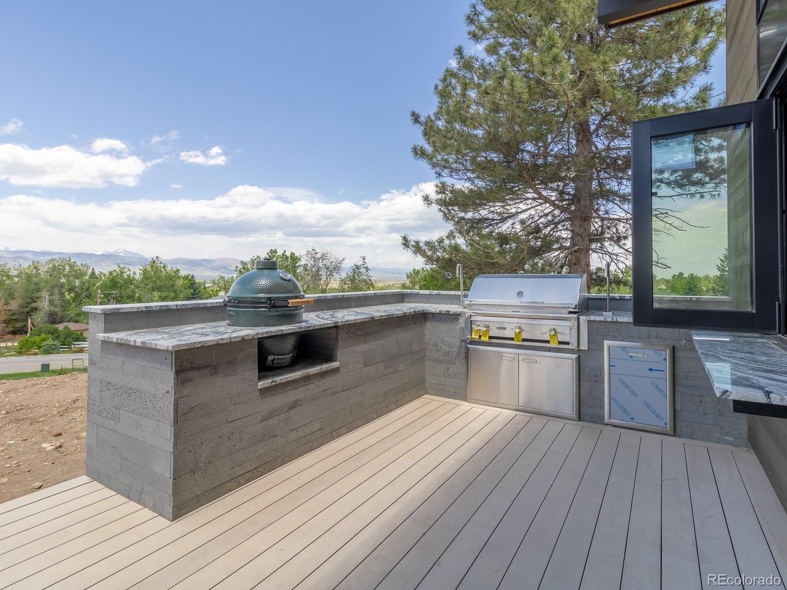 7526 Spring Drive Boulder, CO 80303 - Photo 38 of 40 a kitchen with kitchen island a counter top a stove and a wooden floors