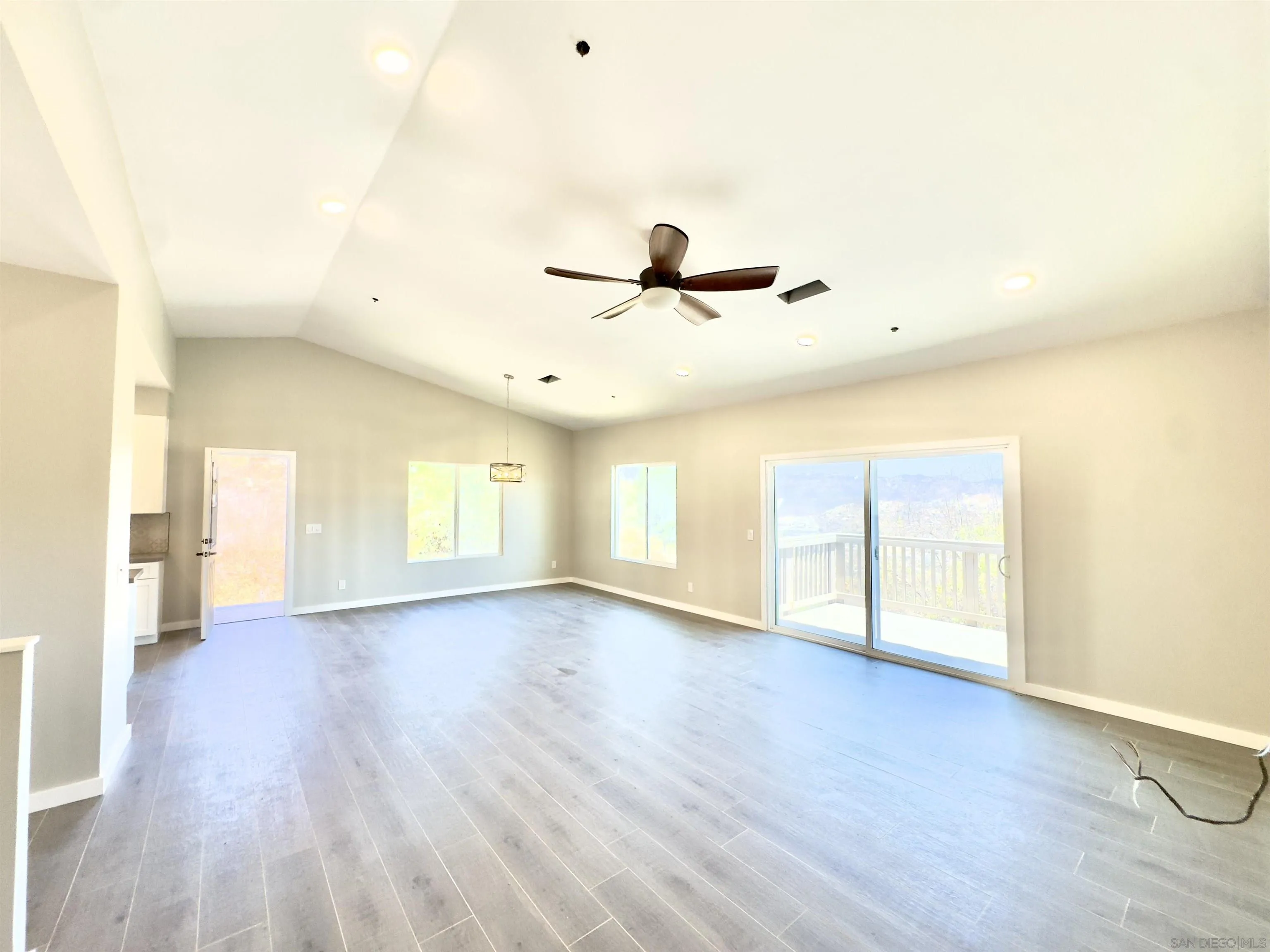 11677 Valle Vista Road Lakeside, CA 92040 - Photo 18 of 44 a view of an empty room with a window and wooden floor