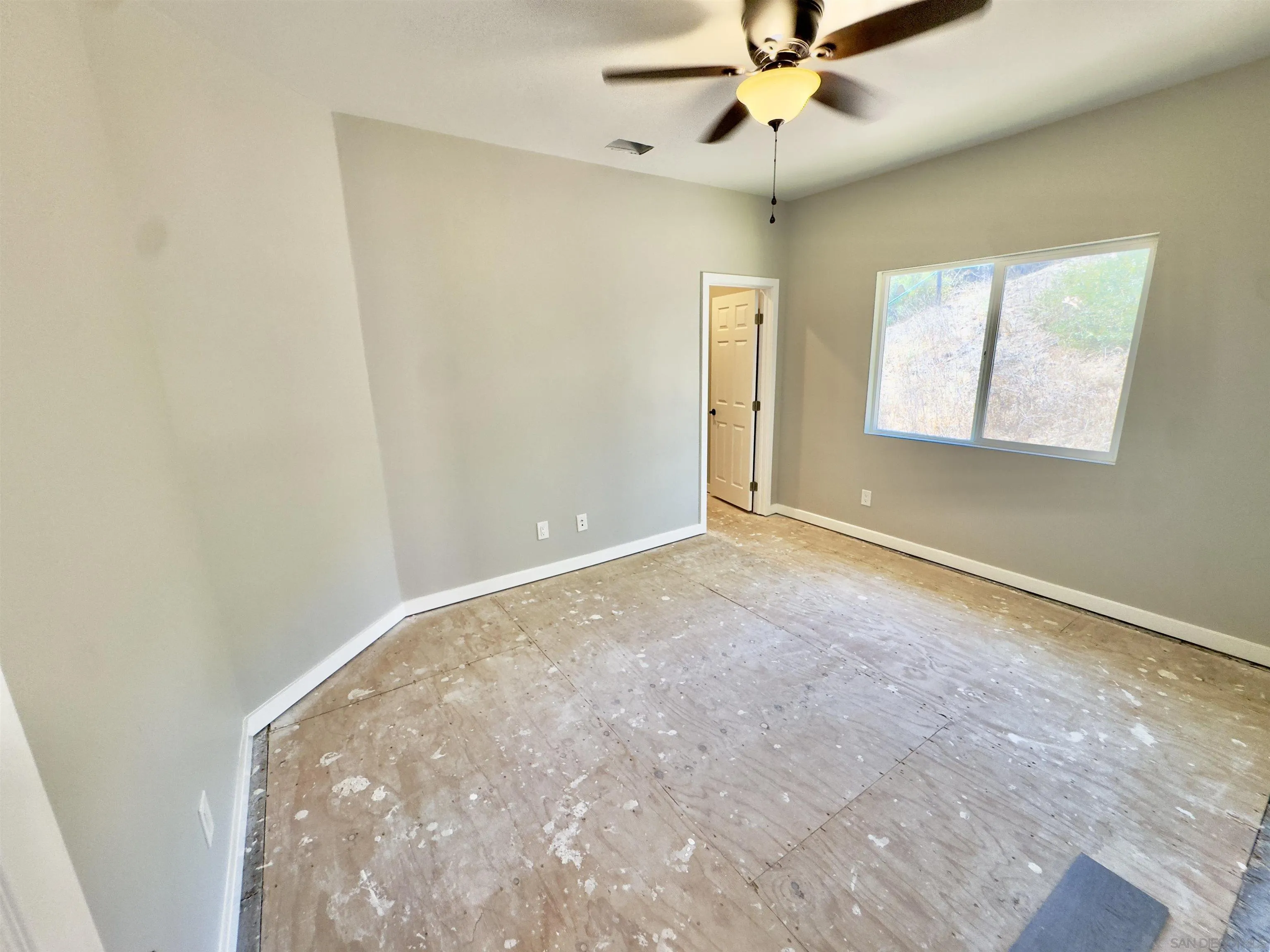 11677 Valle Vista Road Lakeside, CA 92040 - Photo 21 of 44 an empty room with windows and fan