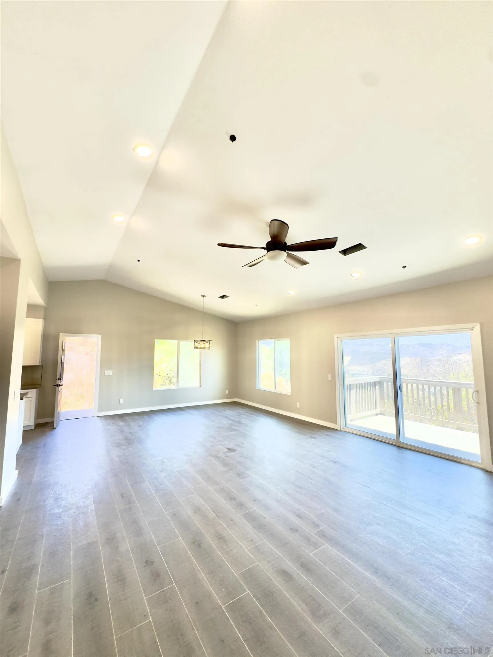 11677 Valle Vista Road Lakeside, CA 92040 - Photo 34 of 44 a view of an empty room with a window and wooden floor