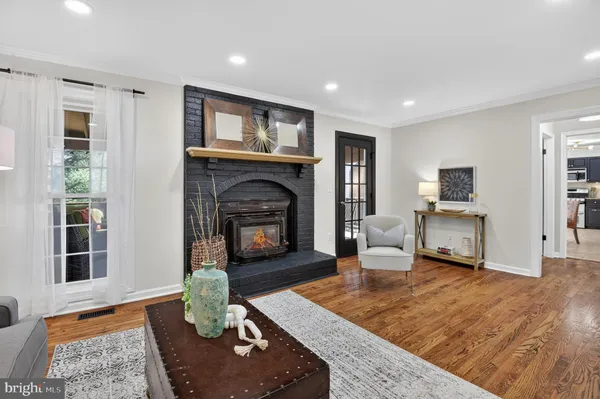 a living room with furniture and stairs