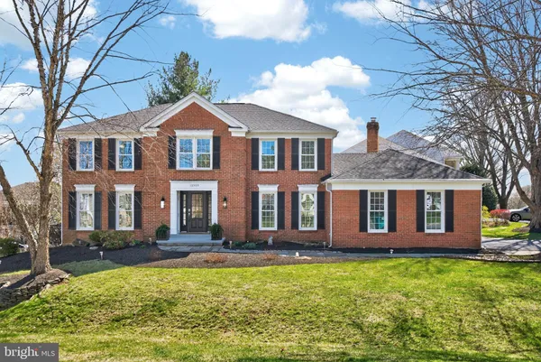 a living room with furniture a flat screen tv and a wooden floor