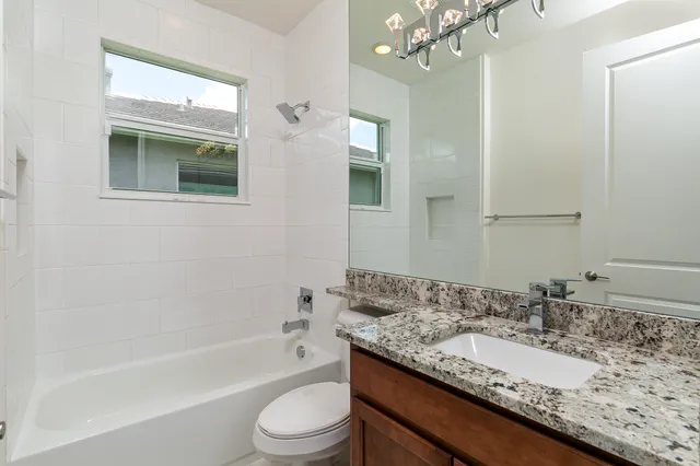 an empty room with mirror and shower