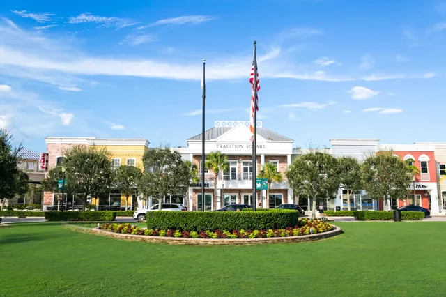 a view of a city with lawn chairs and large trees