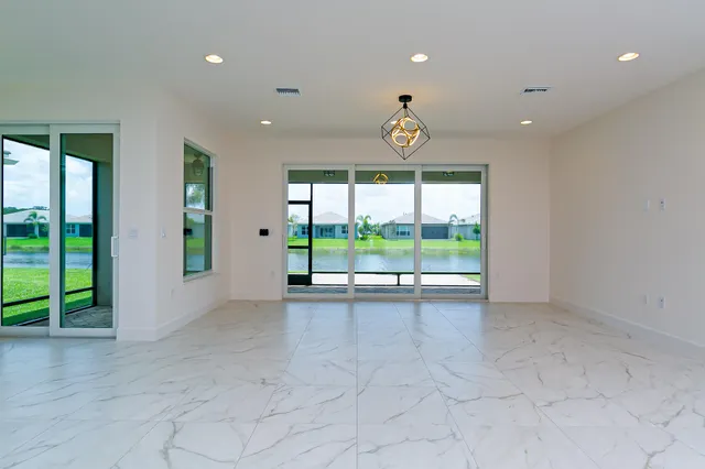 a view of an empty room with a sliding door and balcony view