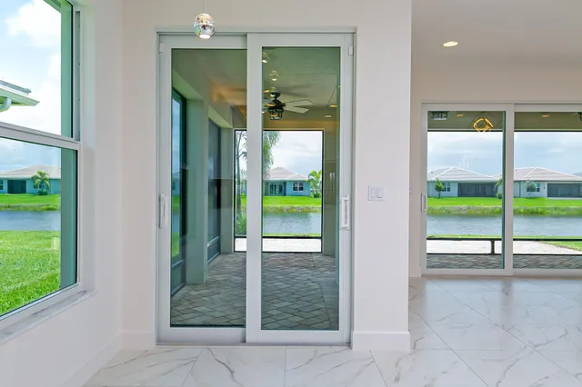 a kitchen with stainless steel appliances granite countertop a sink a stove a refrigerator and a microwave