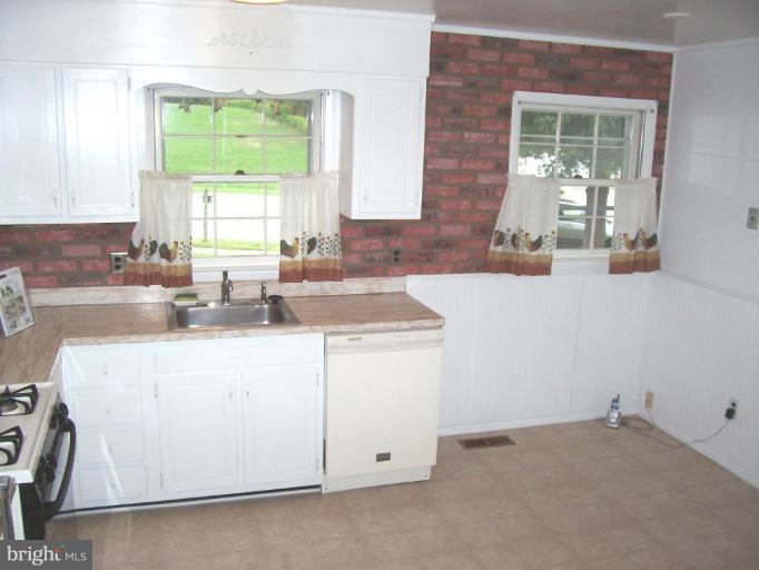 9105 Kilbride Road Nottingham, MD 21236 - Photo 11 of 13 a kitchen with a sink cabinets and window