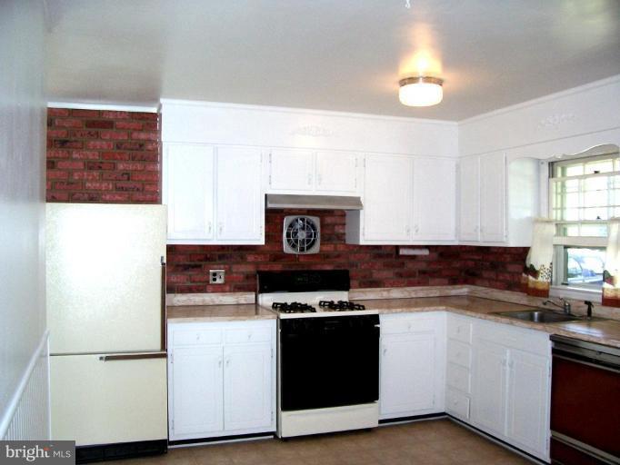9105 Kilbride Road Nottingham, MD 21236 - Photo 7 of 13 a kitchen with granite countertop a stove and a sink