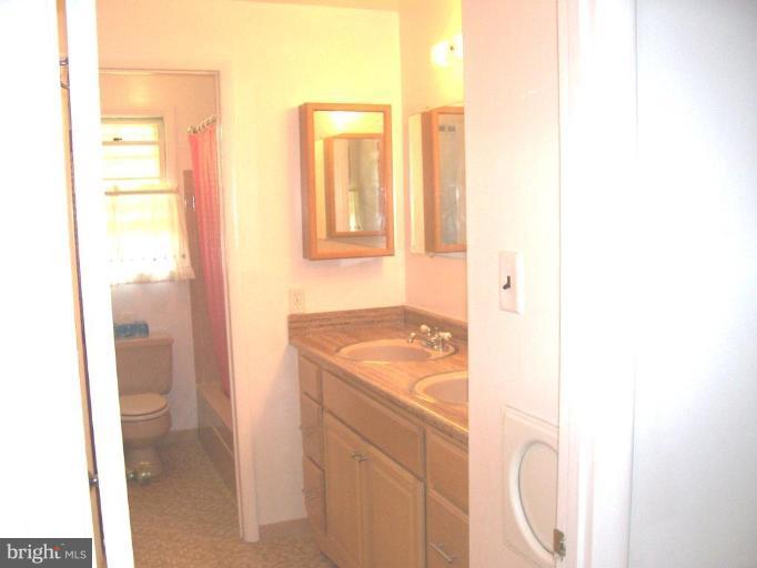 9105 Kilbride Road Nottingham, MD 21236 - Photo 10 of 13 a bathroom with a sink and a mirror