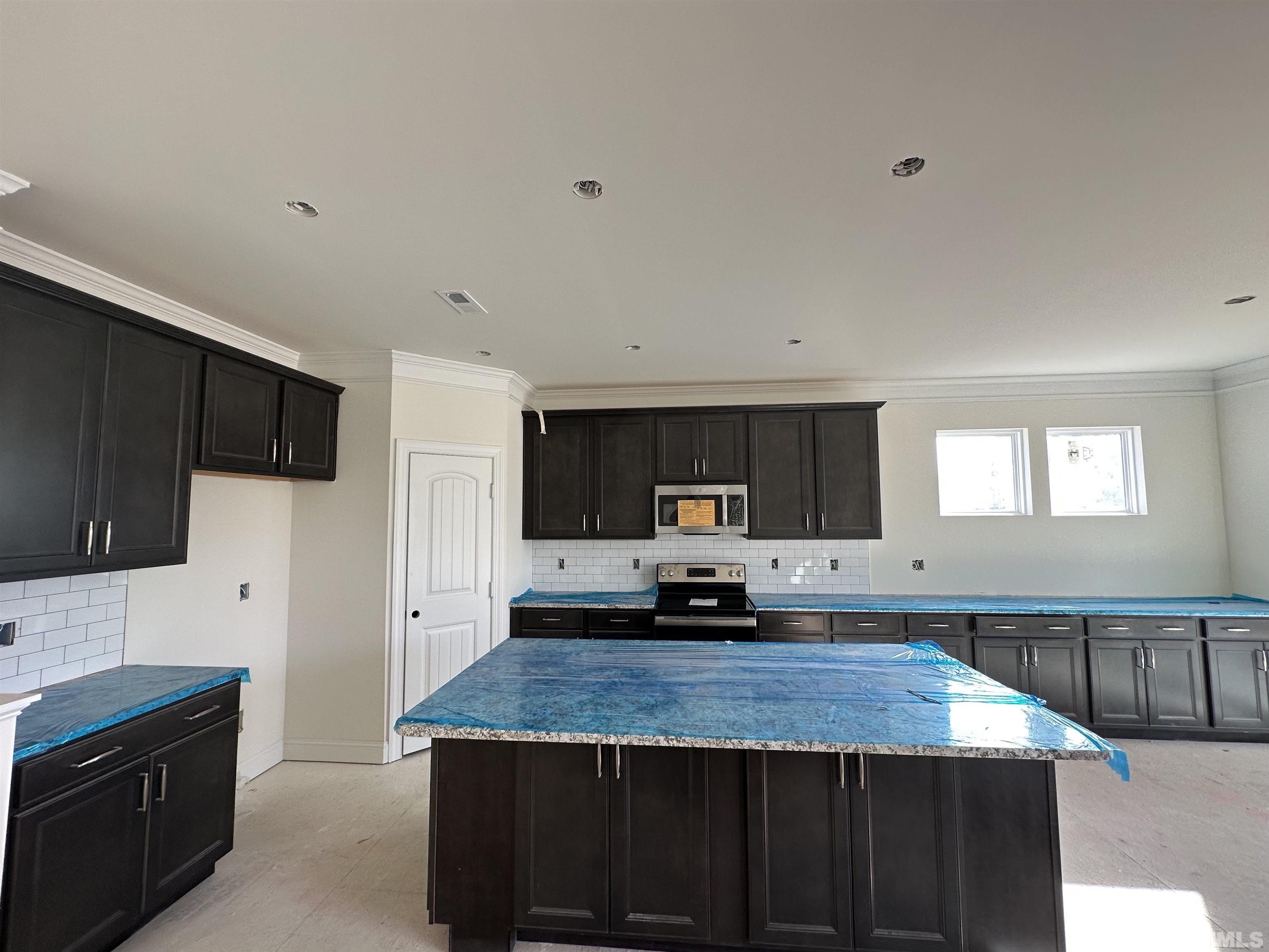 4400 Beckel Road Willow Spring, NC 27592 - Photo 3 of 27 a kitchen with kitchen island granite countertop a stove and a sink