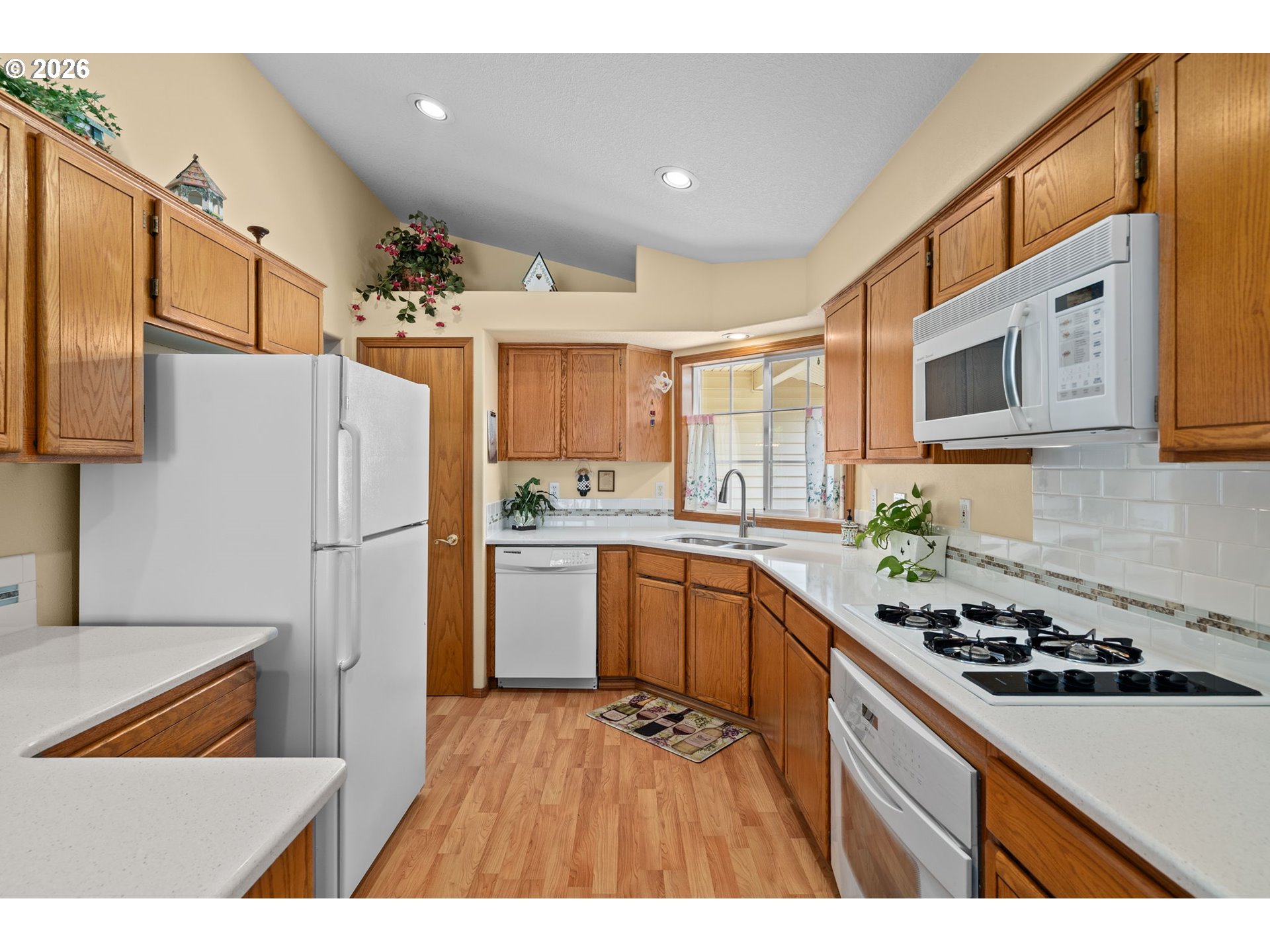 3081 Southwest 31st Street Gresham, OR 97080 - Photo 25 of 38 a kitchen with a refrigerator and a sink
