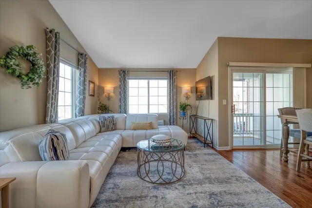 a living room with furniture wooden floor and a table