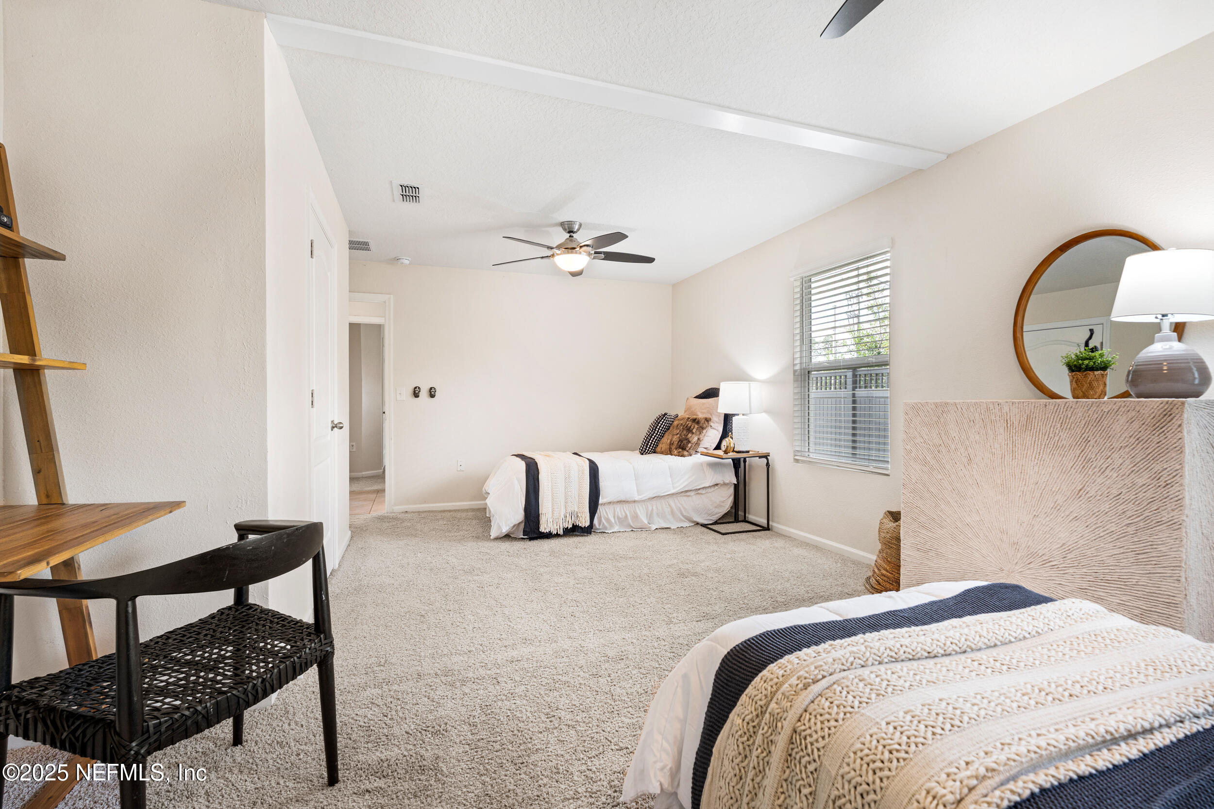 86204 Buggy Court Yulee, FL 32097 - Photo 13 of 23 a bedroom with a bed and a chandelier