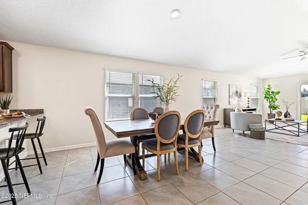 a dining room with furniture and wooden floor