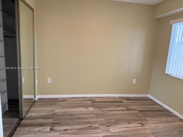 850 Southwest 138th Avenue, Unit 410D Pembroke Pines, FL 33027 - Photo 11 of 29 a view of an empty room with wooden floor and a window