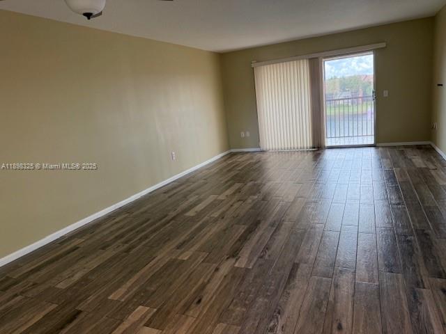 850 Southwest 138th Avenue, Unit 410D Pembroke Pines, FL 33027 - Photo 14 of 29 a view of an empty room with wooden floor and a window