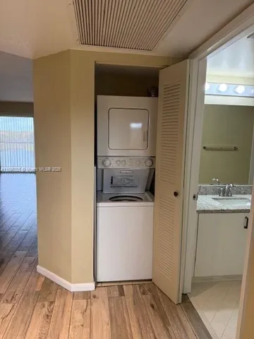 a view of hallway with wooden floor
