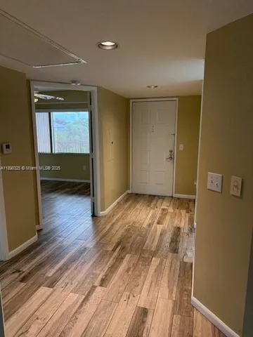 a view of room with wooden floor and window