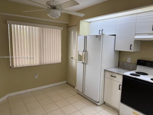 850 Southwest 138th Avenue, Unit 410D Pembroke Pines, FL 33027 - Photo 6 of 29 a kitchen with a refrigerator and a stove top oven