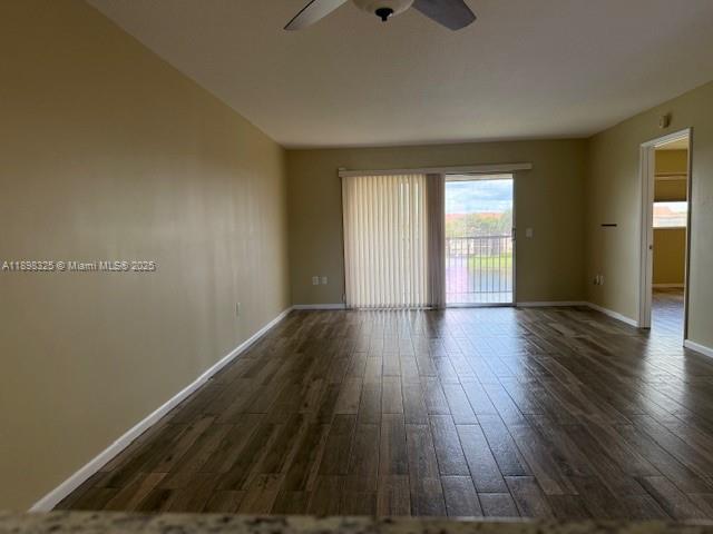 850 Southwest 138th Avenue, Unit 410D Pembroke Pines, FL 33027 - Photo 7 of 29 a view of an empty room with wooden floor and a window