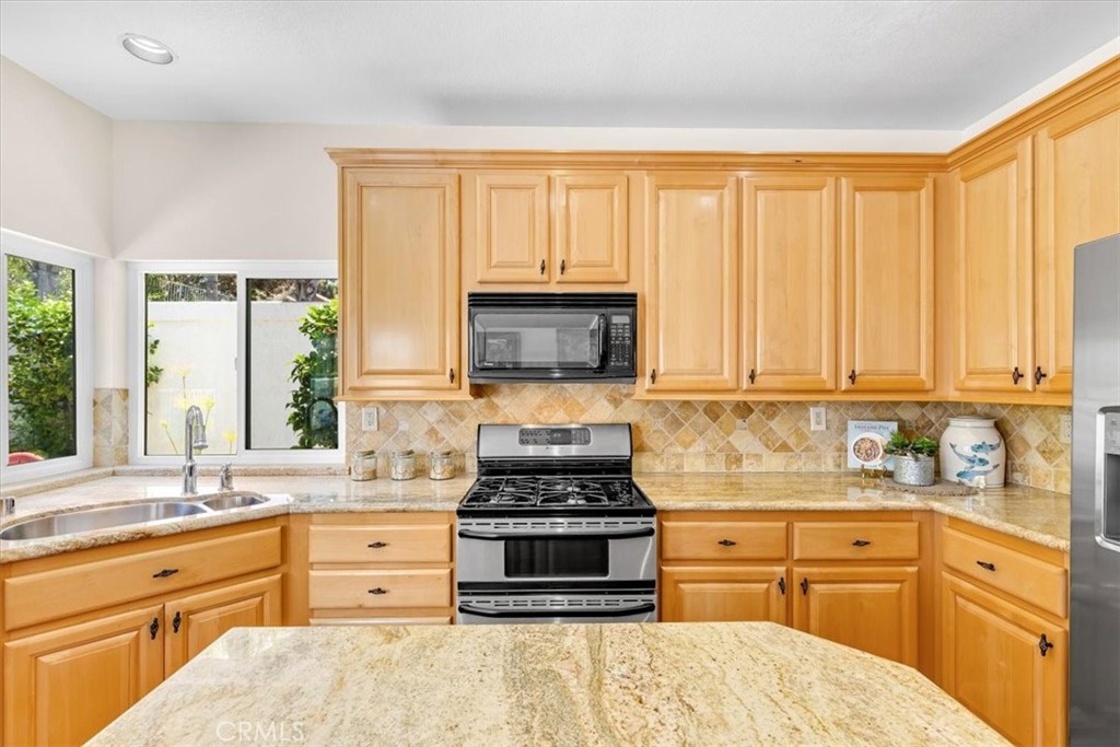 11 Finca San Clemente, CA 92672 - Photo 13 of 55 a kitchen with stainless steel appliances a stove sink and cabinets