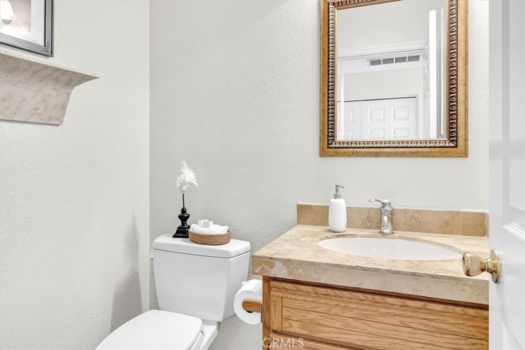 11 Finca San Clemente, CA 92672 - Photo 14 of 55 a bathroom with a granite countertop toilet sink and mirror