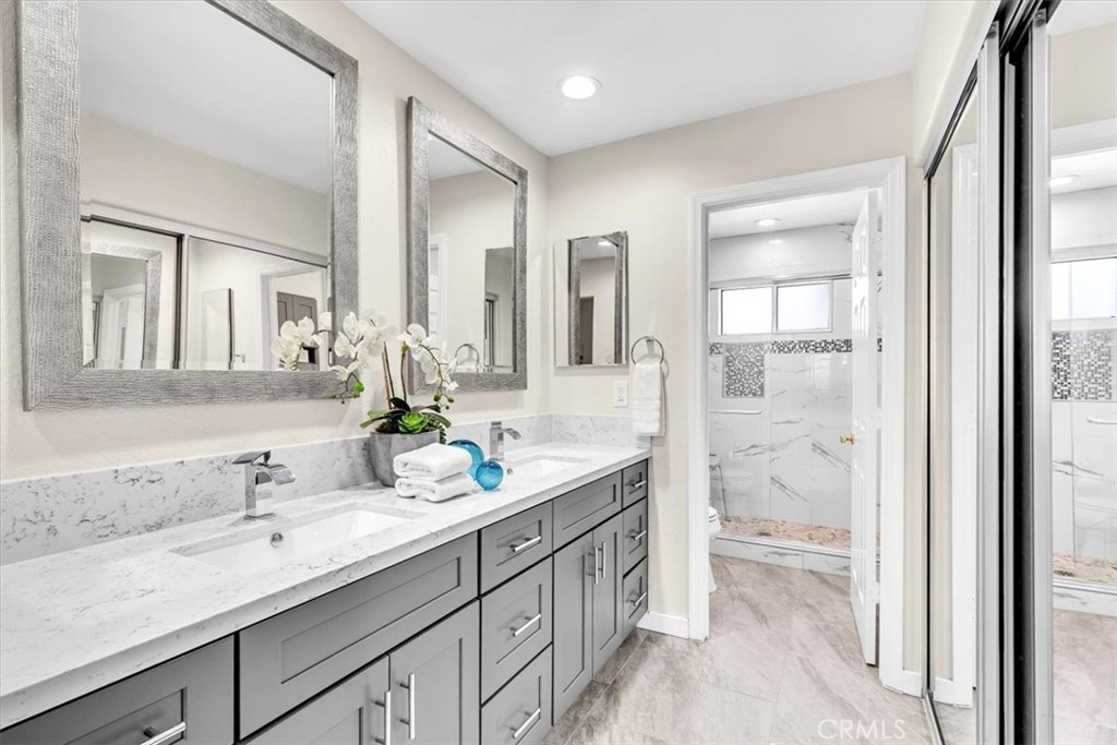 11 Finca San Clemente, CA 92672 - Photo 18 of 55 a spacious bathroom with a shower sink and mirror